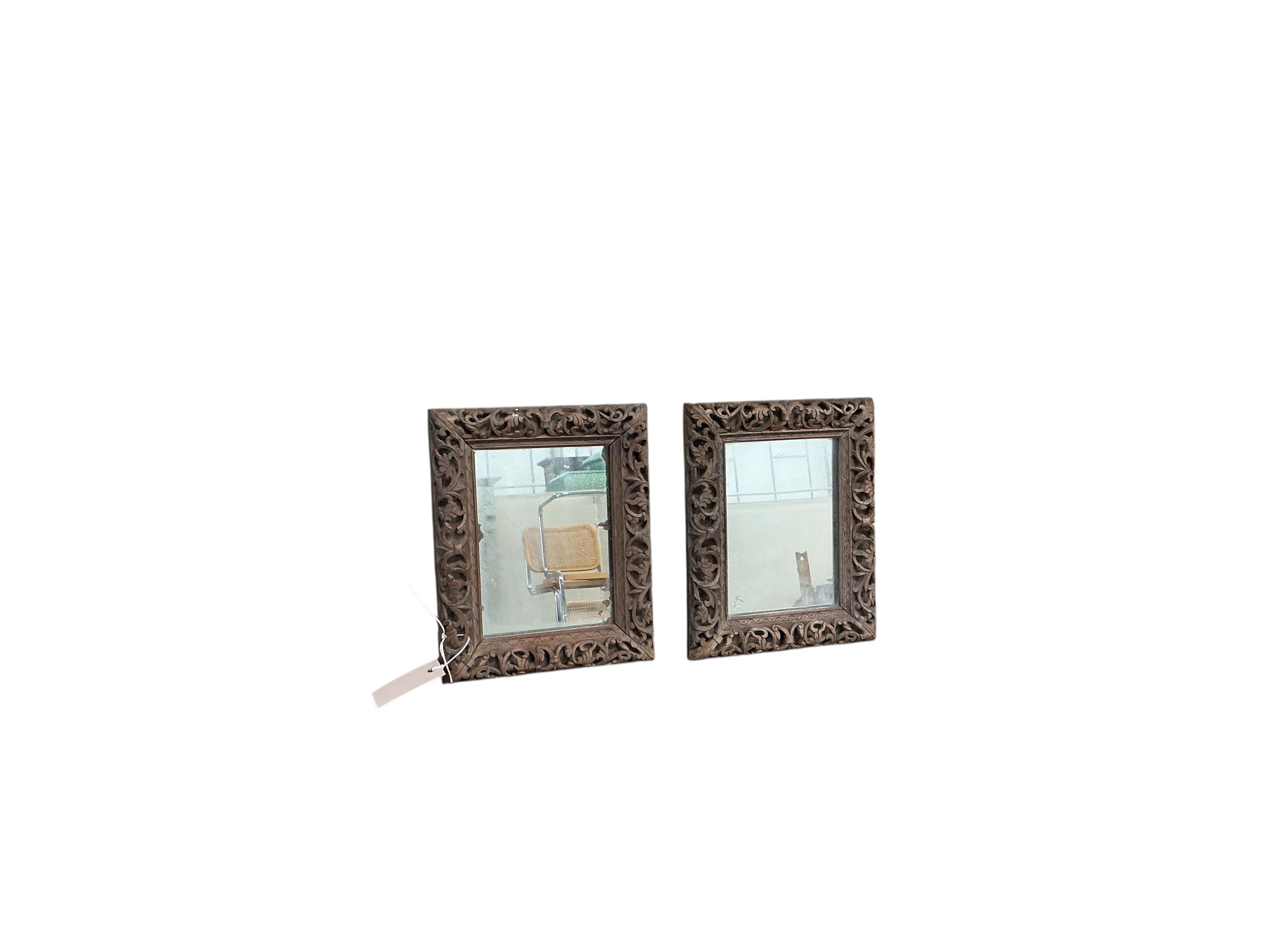 A pair of small Victorian rectangular carved oak wall mirrors, width 22cm, height 28cm